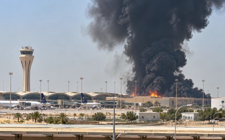 Illustration of smoke rising behind an airport terminal and control tower